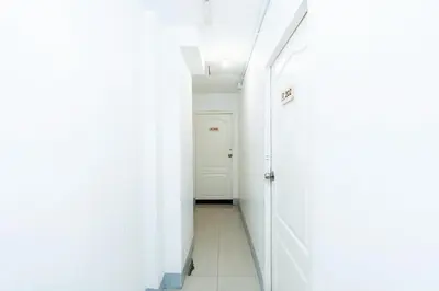 a hallway with white walls and a white door at XX Oh My Nap- Sukhumvit Soi 3 BTS Nana in Bangkok
