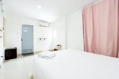 a white bathroom with a sink and a mirror at XX Oh My Nap- Sukhumvit Soi 3 BTS Nana in Bangkok