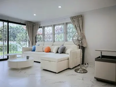 a white couch in a living room with windows at Near Airport 2nd room for 2,8K & 3rd for 1,8K & 4th only 300B INBOX! in Sathani Ban Hua Mak