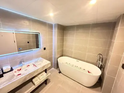 a bathroom with a tub and a sink at Rama9 No1 Hotel in Bangkok