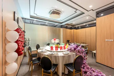 a dining room with a table with a cake and balloons at Rama9 No1 Hotel in Bangkok
