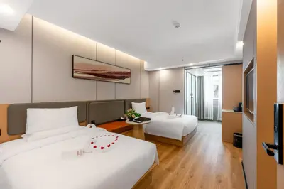 a hotel room with two beds and a table at Rama9 No1 Hotel in Bangkok