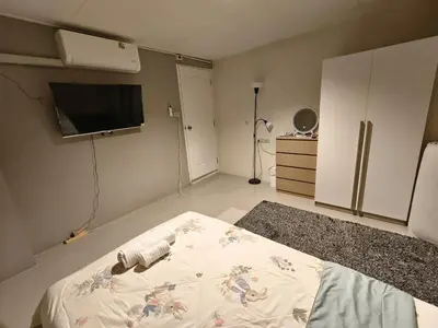 a room with a bed and a flat screen tv at Privacy House in Ban Bang Phai