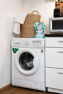 a washing machine with a basket on top of it at King Bed, Park, BTS 5min | Free Parking, Fast WiFi in Khlong Toei