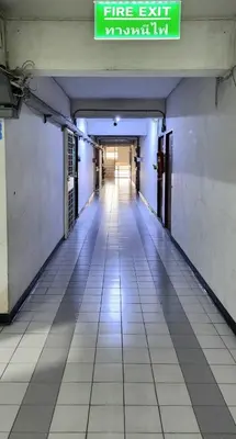 an empty hallway in a building with a sign on it at New room DMKairport,BTS, impact 340 in Ban Song Hong