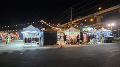 a market with tents and people walking around at night at new room near Don Mueang airport,Impact,BTS 339 in Ban Song Hong