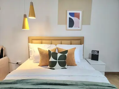 a bedroom with a bed with white sheets and pillows at new room near Don Mueang airport,Impact,BTS 339 in Ban Song Hong