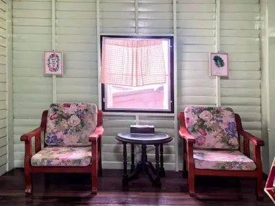 two chairs and a table in a room with a window at Lamduan house whole House - 3BR - Experience temple and canal life in Bangkok