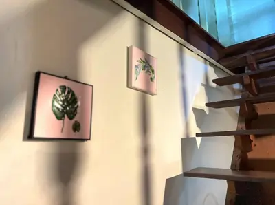 two pictures of plants on the wall of a room at Lamduan house whole House - 3BR - Experience temple and canal life in Bangkok