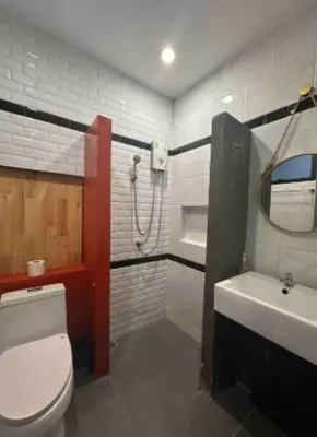 a bathroom with a toilet and a sink and a shower at Garden and pool Villa bangkok in Bang O