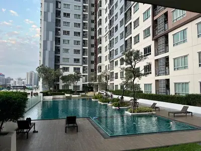 a large swimming pool in the middle of a building at Prime Near Sathorn Sukhumvit Central in Chong Nonsi