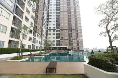 a pool in the middle of a building with a bench at Prime Near Sathorn Sukhumvit Central in Chong Nonsi