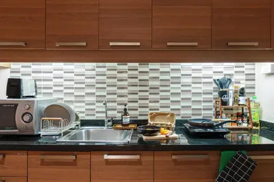 a kitchen counter with a sink and a microwave at King suite with kitchen-Short walk to Park,BTS,Mall in Khlong Toei