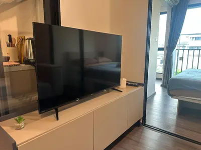 a large flat screen tv sitting on a dresser in a room at Brand new Condo near ICON SIAM in Bangkok