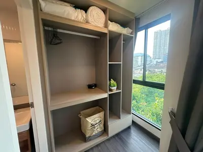 a walk in closet with shelves and a window at Brand new Condo near ICON SIAM in Bangkok