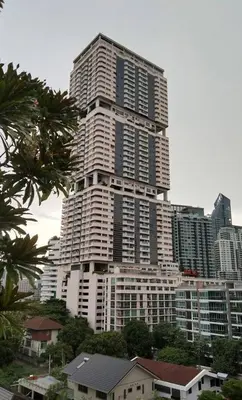 a large tall building in the middle of a city at 1br with Pool Gym near BTS Phrom Phong in Khlong Toei
