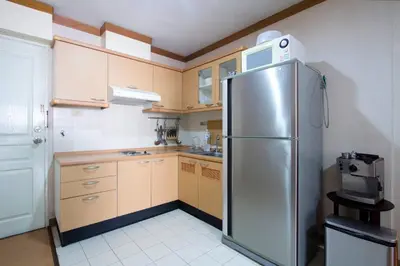a kitchen with a stainless steel refrigerator at 1br with Pool Gym near BTS Phrom Phong in Khlong Toei