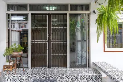 an entrance to a house with a glass door at 110 House 4Bedroom in Ban Zong Katiam
