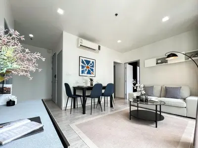 a living room with a table and a couch at Tranquil Apt 2 BR - Ultra Fast Wifi - BTS On Nut in Bangkok