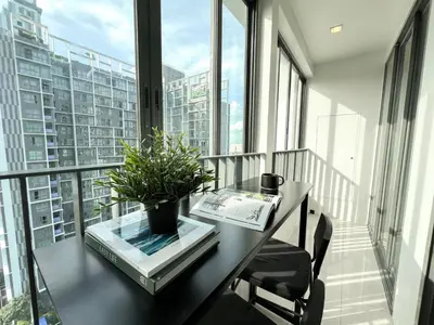 a balcony with a table with a potted plant on it at Tranquil Apt 2 BR - Ultra Fast Wifi - BTS On Nut in Bangkok