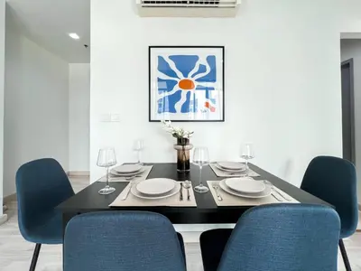 a dining room with a black table and blue chairs at Tranquil Apt 2 BR - Ultra Fast Wifi - BTS On Nut in Bangkok