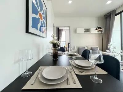 a dining room table with plates and wine glasses at Tranquil Apt 2 BR - Ultra Fast Wifi - BTS On Nut in Bangkok
