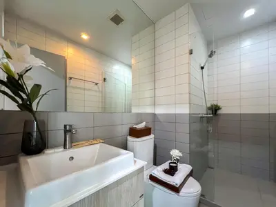 a bathroom with a tub and a toilet and a sink at Tranquil Apt 2 BR - Ultra Fast Wifi - BTS On Nut in Bangkok