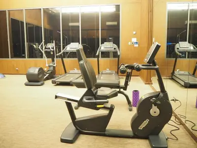 a gym with a row of exercise bikes and ellipticals at Circle Sukhumvit31 Bangkok #2BR #5ppl in Bangkok