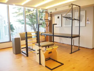 a room with a gym with a treadmill and a bench at Circle Sukhumvit31 Bangkok #2BR #5ppl in Bangkok