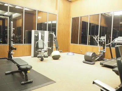 a gym with a lot of exercise equipment and mirrors at Circle Sukhumvit31 Bangkok #2BR #5ppl in Bangkok