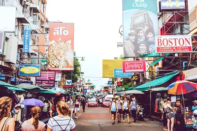 a busy city street with people walking down the street at xx GO INN Khaosan BKK - โกอินน์ ข้าวสาร in Bang Bua Thong Railway Station