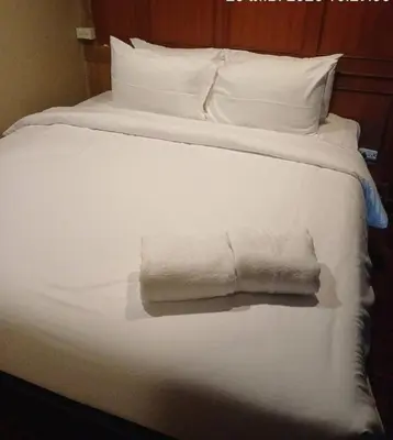 a white bed with two folded towels on it at xx Stay On Sukhumvit Soi 11 BTS Nana - สเตย์ออน สุขุมวิท 11 รถไฟฟ้านานา in Makkasan
