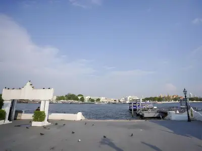 a dock with a boat in a body of water at xx GO INN Siriraj BKK โกอินน์ ศิริราช in Bangkok Noi