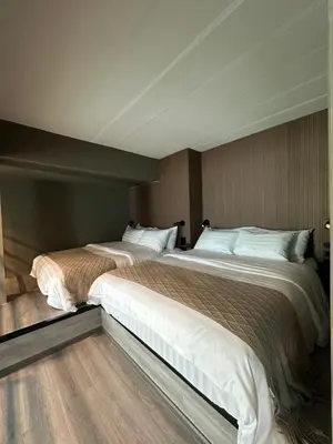 a bedroom with two beds with white pillows at Thai Loft \u6cf0\u95a3 in Bangkok