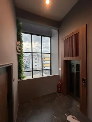 a room with a window with a view of a city at Thai Loft \u6cf0\u95a3 in Bangkok