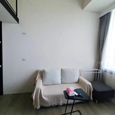 a living room with a couch and a table at BTS onnut loft quiet room Netflix Rooftop bar in Bangkok