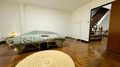 a white room with a bed and a rug at Creative Bangkok Bed in Sathani Bang Khen