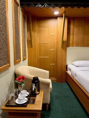 a hotel room with a bed and a table with a coffee maker at The Rich Hotel Rama 5 in Ban Bang Phai