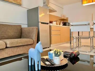 a living room with a couch and a table at Sathorn Prime Residence 1BR #Bangkok in Bangkok
