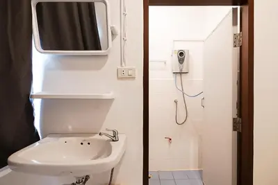 a bathroom with a toilet and a tv on the wall at xx GO INN Asiatique BKK - โกอินน์ เอเชียทีค เจริญกรุง in Godown