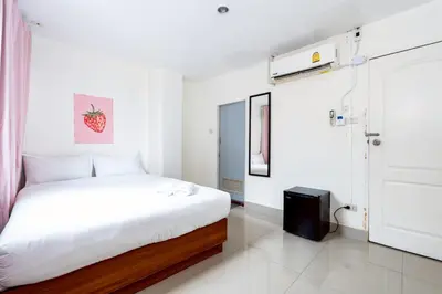 a white bedroom with a bed and a tv at XX Oh My Nap - BTS Nana โอ้ มาย แนป ซอยนานา in Bangkok