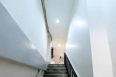 a staircase in a building with a stair case at XX Oh My Nap - BTS Nana โอ้ มาย แนป ซอยนานา in Bangkok