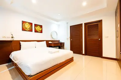 a bedroom with a large bed and a desk at YON INN Sukhumvit 4 BTS Nana in Bangkok