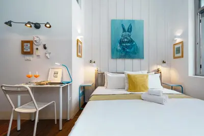 a small room with two beds and a desk at Non Inn Entire Historic 5 Bedroom Riverside Shophouse near ICONSIAM for Families and Groups in Bang Rak