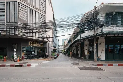 an empty street in a city with buildings at Non Inn The Post Spacious King Room with Sofa Bed and Living Area near Riverside and ICONSIAM in Bang Rak