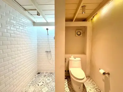 a bathroom with a toilet and a shower at Non Inn The Barber King and Twin Rooms with Vintage Charm and Unique Design near Riverside and ICONSIAM in Bang Rak