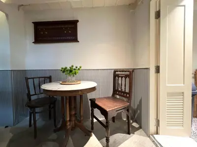a table and two chairs in a room at Non Inn The Barber King and Twin Rooms with Vintage Charm and Unique Design near Riverside and ICONSIAM in Bang Rak