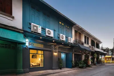 a blue building with speakers on the side of it at Non Inn The Diamond Artisan and Barber 4 Bedroom Riverside Retreat with King and Twin Rooms in Bang Rak