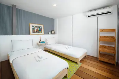 a room with two beds in a room at Non Inn The Diamond Artisan King and Twin Rooms with Private Coffee Station and InnerCourt Quiet View near Riverside and ICONSIAM in Bang Rak