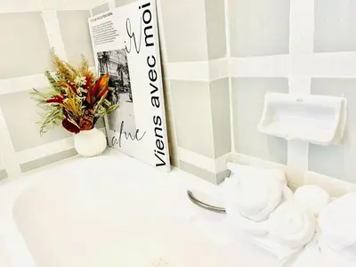 a bathroom with a book and a pile of towels at Private Pool Villas Sukhumvit 26 Near BTS Phrom Phong and EmSphere in Bangkok